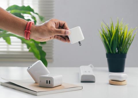 person removing plug from power strip